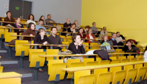 group-cheerful-happy-students-sitting-lecture-hall-before-lesson 1